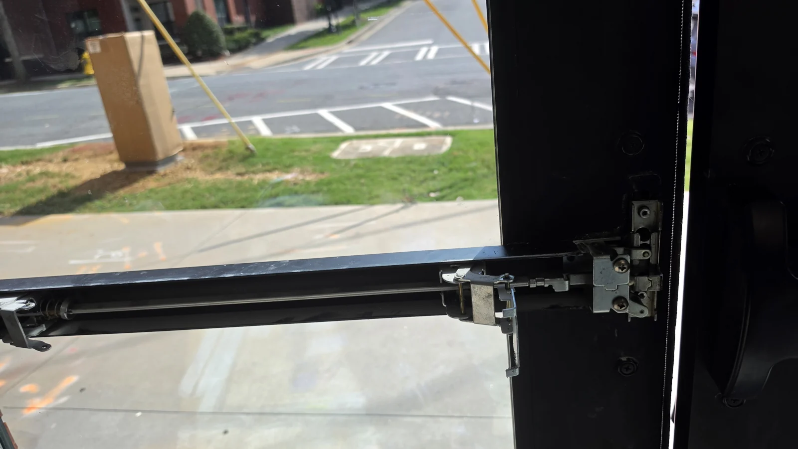 Commercial exit hardware with its cover removed during repair.
