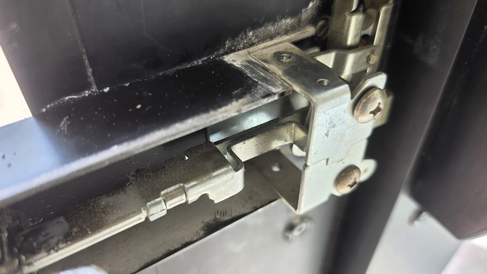 Close-up of the exposed panic bar mechanism during the work.